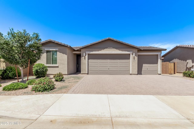 1268 E Jahns Dr, Casa Grande, AZ 85122 - ranch-style house with fence, decorative driveway, stucco siding, an attached garage, and a tile roof