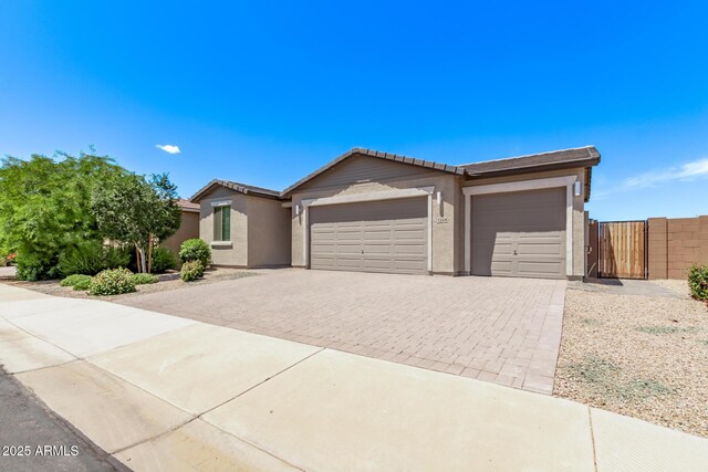 1268 E Jahns Dr, Casa Grande, AZ 85122 - ranch-style house with stucco siding, decorative driveway, a tiled roof, and a garage