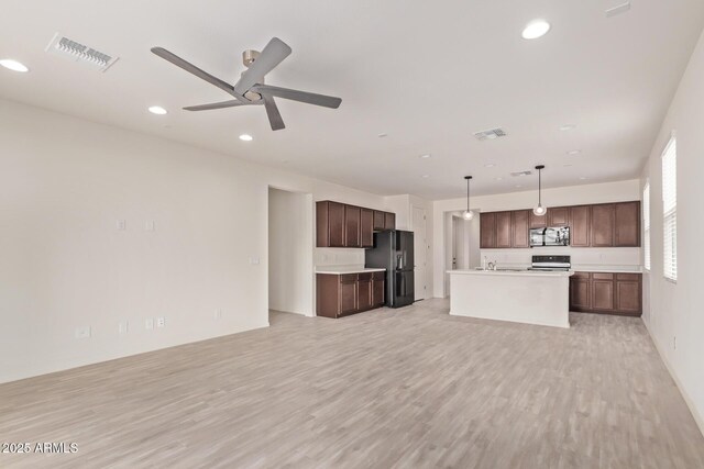 1268 E Jahns Dr, Casa Grande, AZ 85122 - unfurnished living room with recessed lighting, visible vents, and light wood-style flooring
