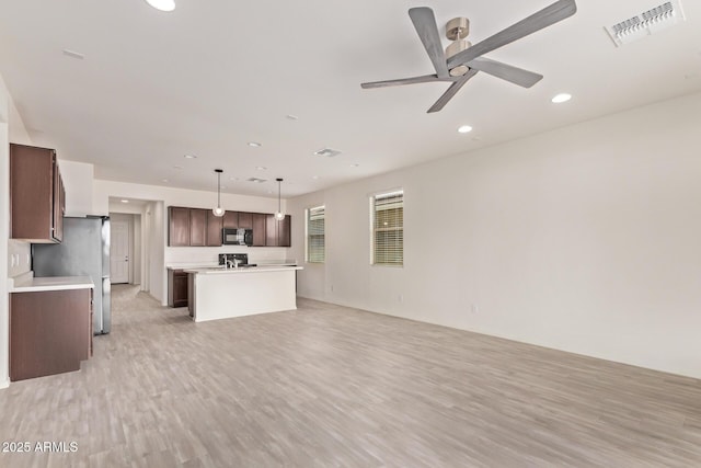 1268 E Jahns Dr, Casa Grande, AZ 85122 - kitchen with visible vents, black microwave, open floor plan, light countertops, and a ceiling fan