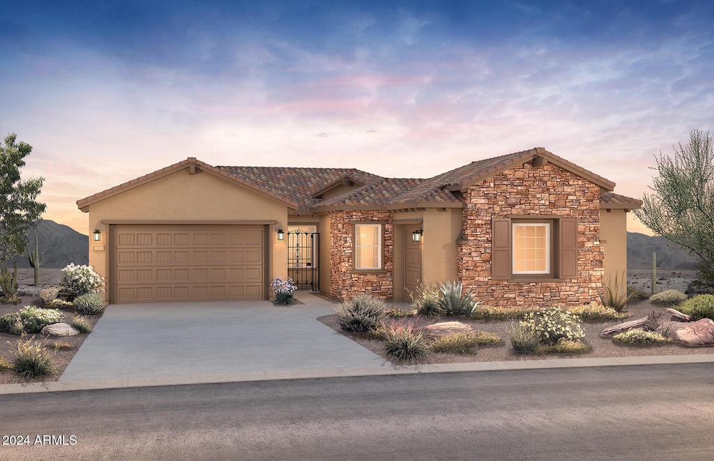 view of front facade featuring a mountain view and a garage