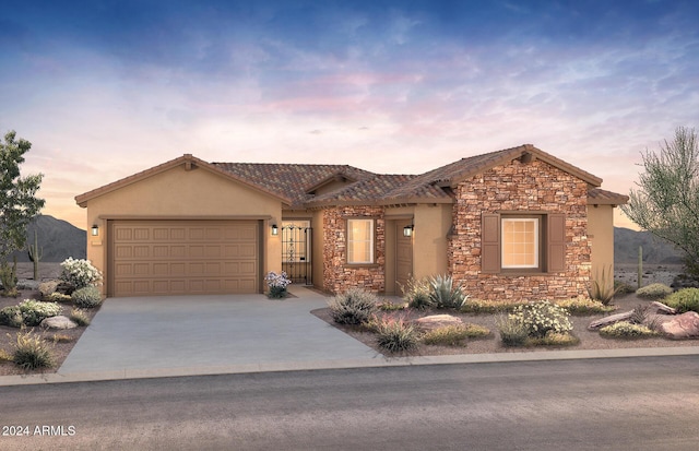 view of front facade featuring a mountain view and a garage