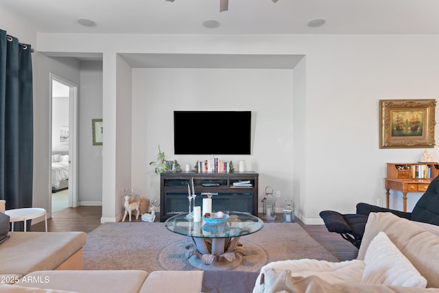 living area featuring ceiling fan, wood finished floors, and baseboards