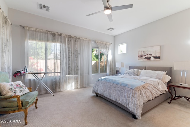 bedroom with light carpet and ceiling fan