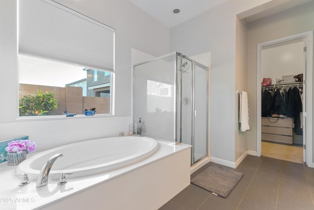 bathroom with independent shower and bath and tile patterned flooring