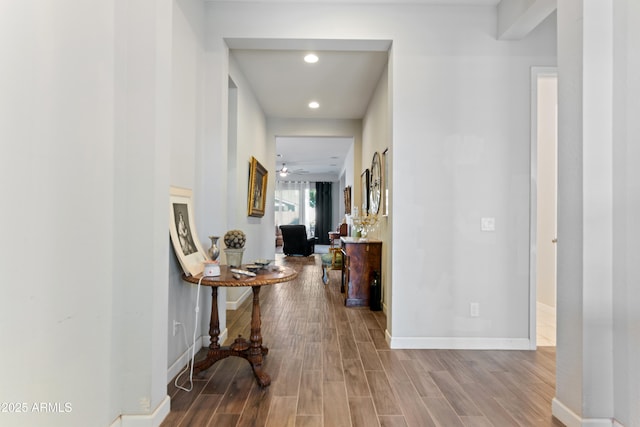 hall with baseboards, wood finished floors, and recessed lighting