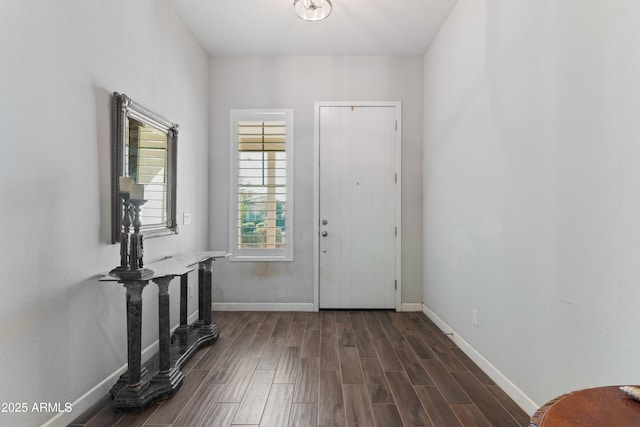 entryway with dark wood-style flooring and baseboards