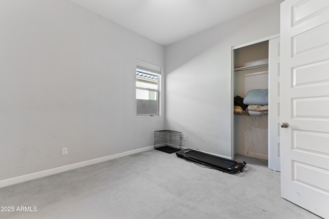 bedroom featuring carpet, baseboards, and a closet