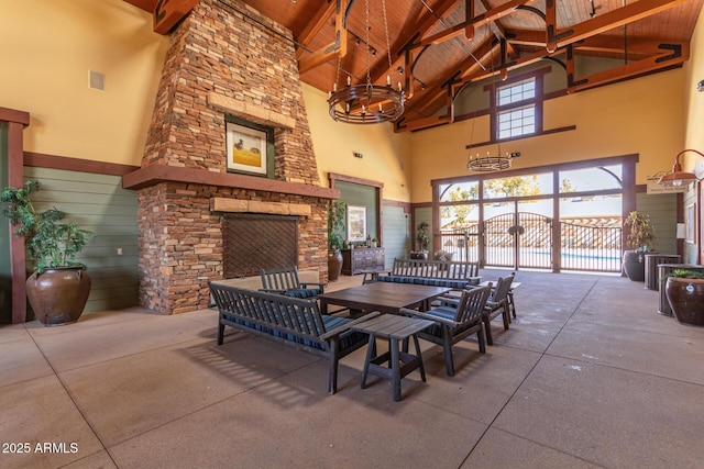 interior space with an outdoor stone fireplace, fence, and a gate