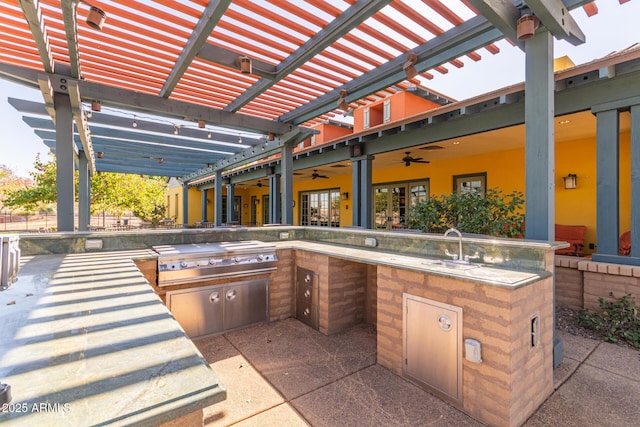 view of patio featuring area for grilling, a grill, sink, ceiling fan, and a pergola