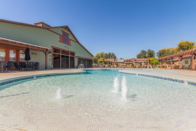 pool with a patio and a pergola