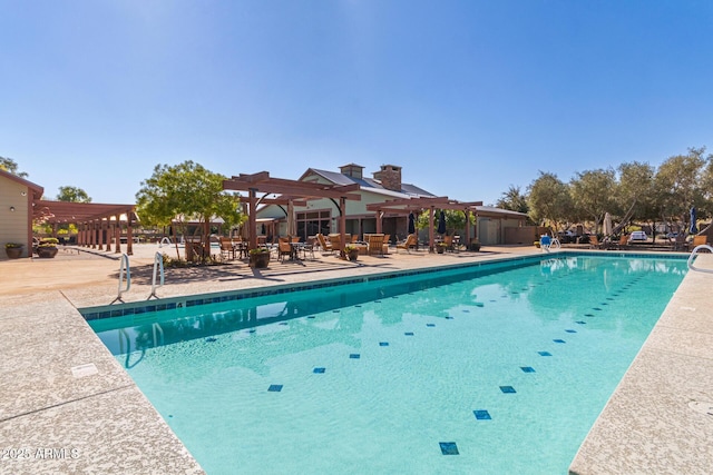 pool with a patio and a pergola