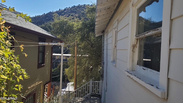 view of property exterior with a mountain view