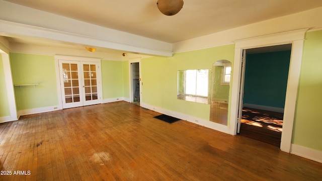 unfurnished room with hardwood / wood-style flooring and french doors