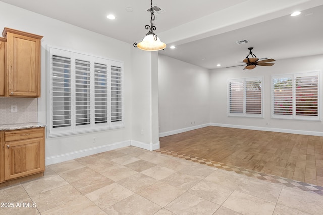 unfurnished dining area with light tile patterned flooring and ceiling fan