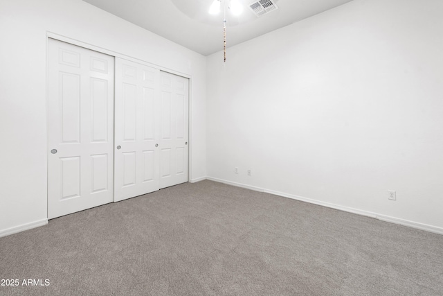 unfurnished bedroom with carpet and a closet