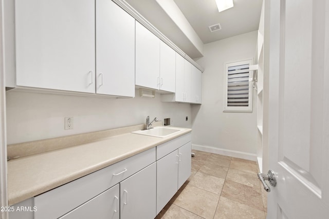 laundry area with sink, cabinets, light tile patterned floors, electric dryer hookup, and washer hookup