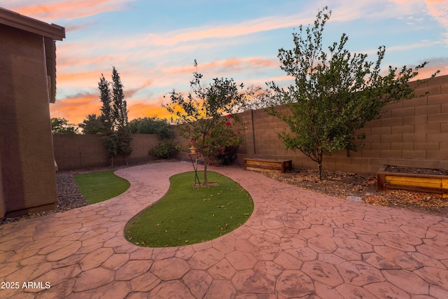 view of patio terrace at dusk