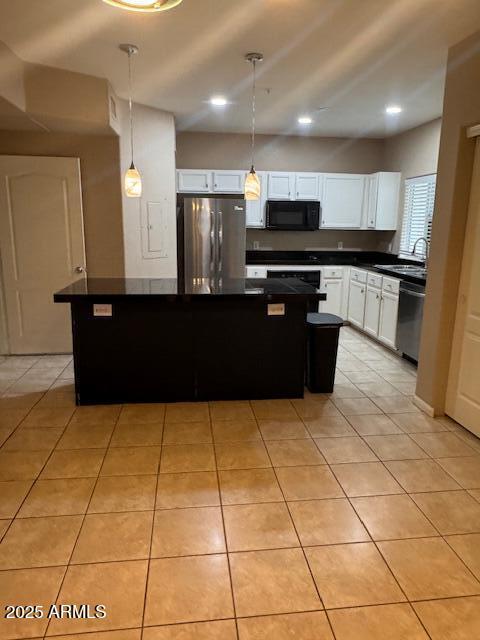 1081 W 1st St Unit 10, Tempe, AZ 85281 - kitchen featuring appliances with stainless steel finishes, dark countertops, light tile patterned floors, white cabinetry, and recessed lighting