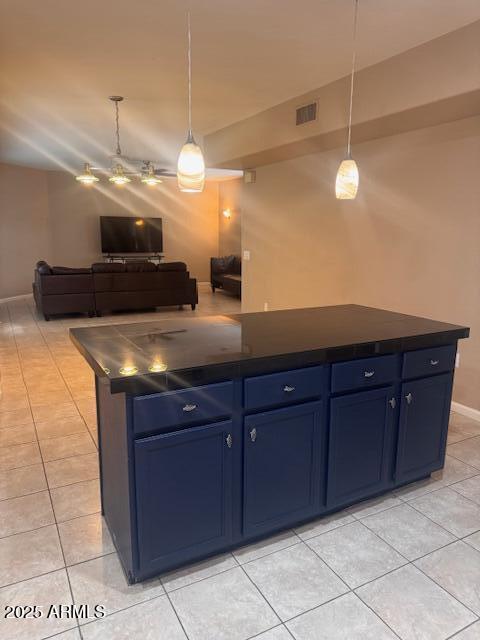 1081 W 1st St Unit 10, Tempe, AZ 85281 - kitchen featuring dark countertops, blue cabinetry, light tile patterned floors, and open floor plan