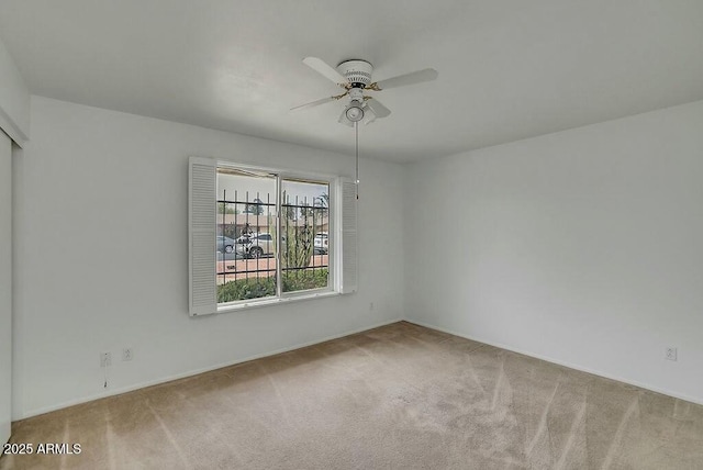 spare room with carpet flooring and ceiling fan