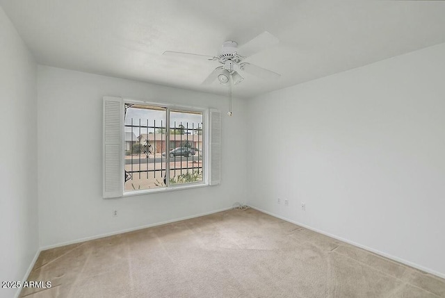 unfurnished room with baseboards, carpet floors, and ceiling fan