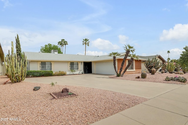 ranch-style home featuring driveway and a garage