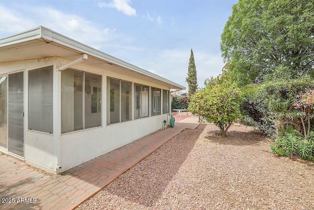 view of side of property with a sunroom