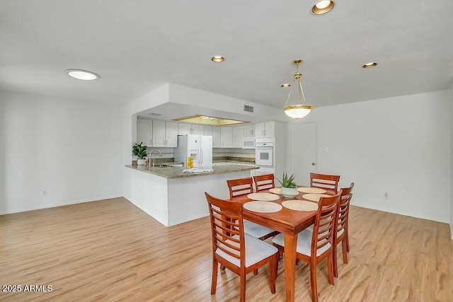 dining room with visible vents, recessed lighting, and light wood finished floors