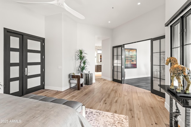 bedroom with hardwood / wood-style floors and french doors