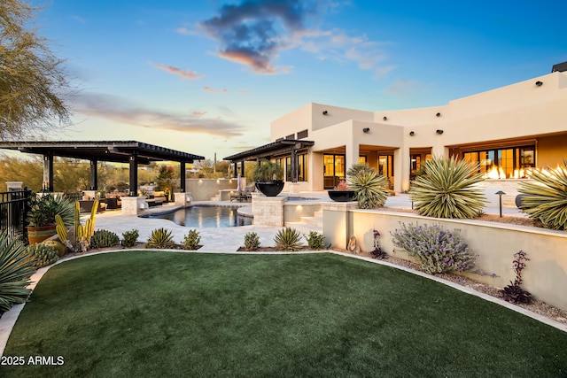 pool at dusk featuring area for grilling, a yard, and a patio area