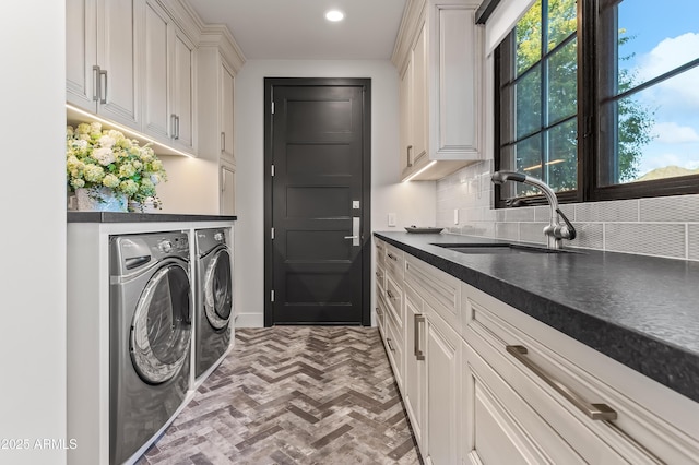 laundry room with sink, cabinets, and independent washer and dryer