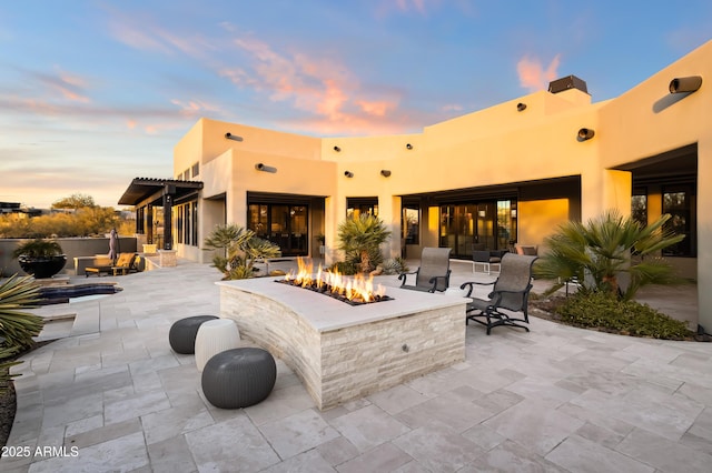 patio terrace at dusk with an outdoor fire pit