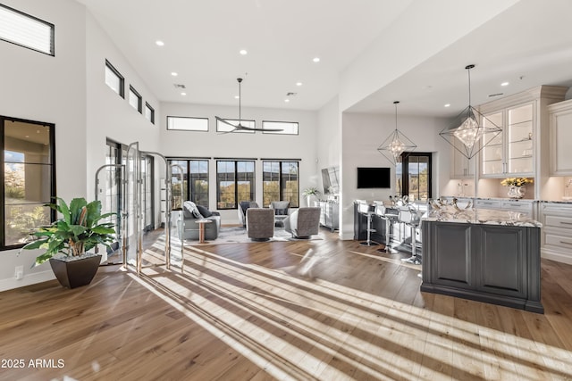 living room with plenty of natural light, hardwood / wood-style floors, and a high ceiling