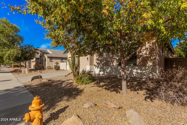 view of property hidden behind natural elements with a garage