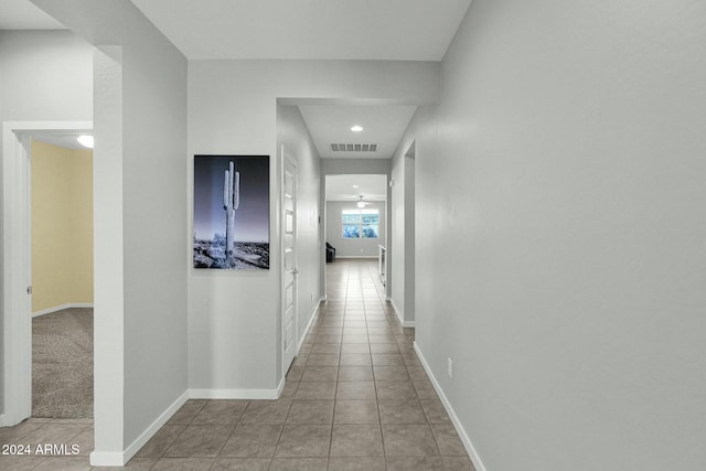 hall featuring light tile patterned floors