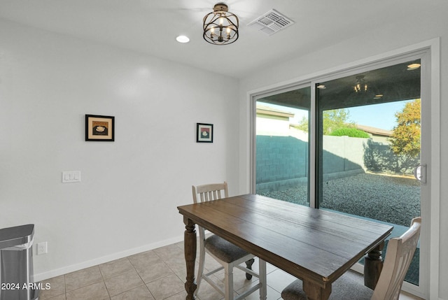 tiled dining area with a notable chandelier