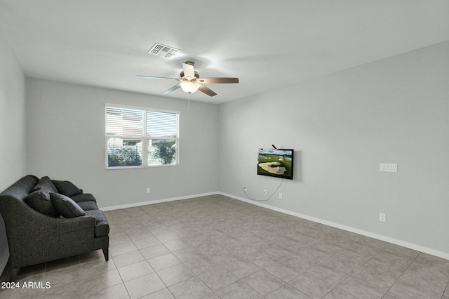 living area with ceiling fan and light tile patterned floors