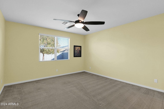 spare room featuring light carpet and ceiling fan