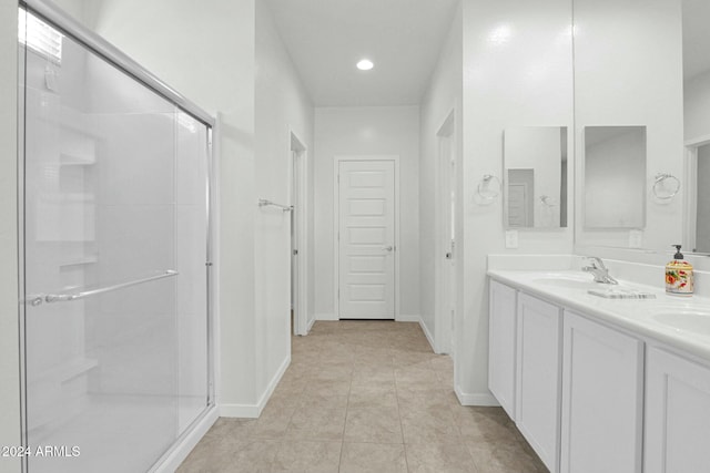 bathroom featuring tile patterned floors, vanity, and walk in shower