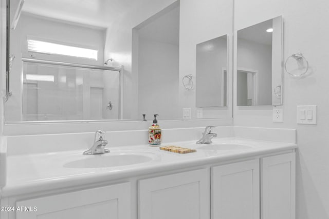 bathroom featuring vanity and a shower with shower door