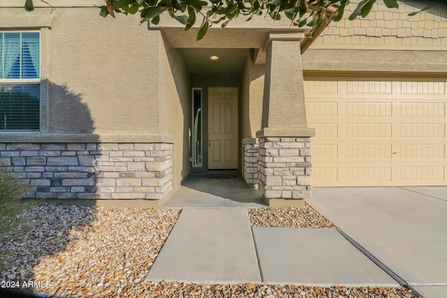 doorway to property with a garage