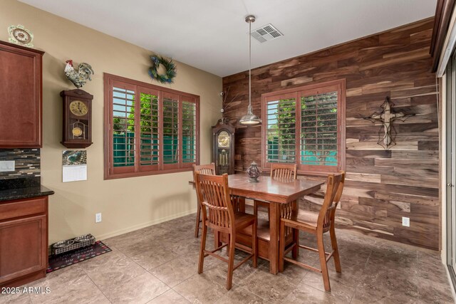20962 W Thomas Rd, Buckeye, AZ 85396 - dining room with wooden walls, healthy amount of natural light, and baseboards