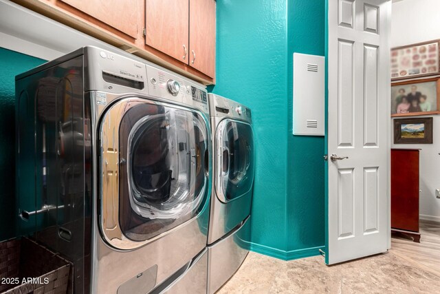 20962 W Thomas Rd, Buckeye, AZ 85396 - laundry area featuring cabinet space, washer and dryer, a textured wall, and baseboards