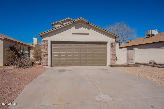 view of front of house with cooling unit, a garage, an outdoor structure, stone siding, and driveway