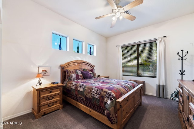 bedroom featuring baseboards, a ceiling fan, and dark colored carpet