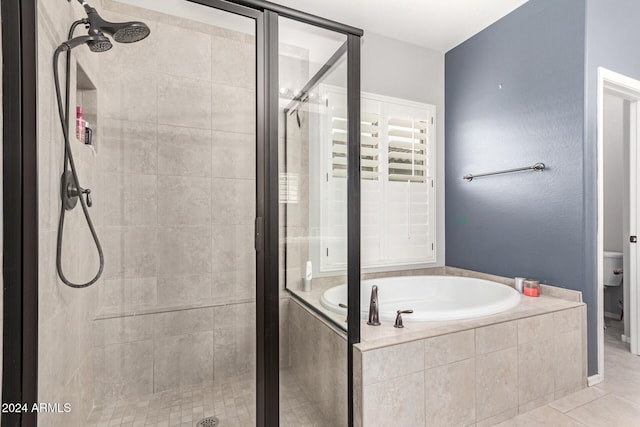 bathroom featuring tile patterned floors, plus walk in shower, and toilet