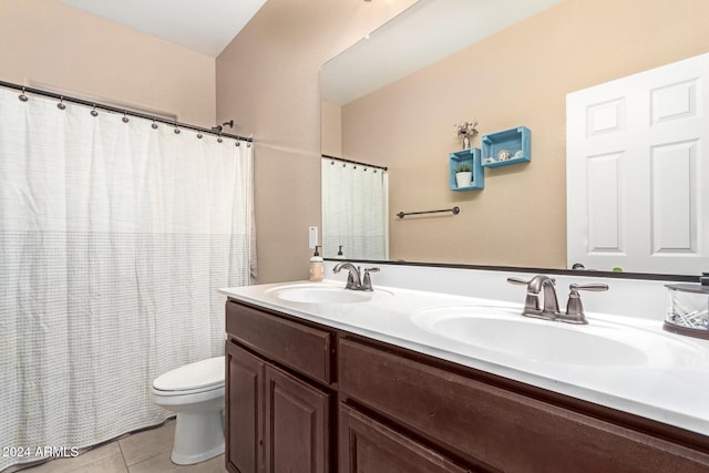 bathroom featuring tile patterned flooring, vanity, and toilet