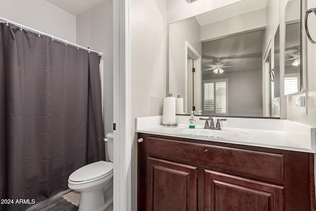 bathroom with vanity, toilet, and ceiling fan