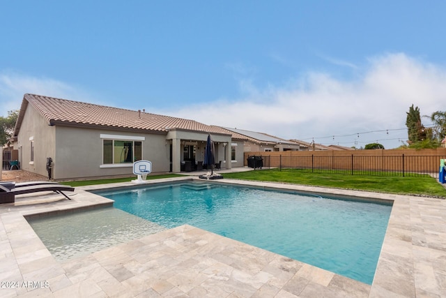 view of pool with a yard and a patio area